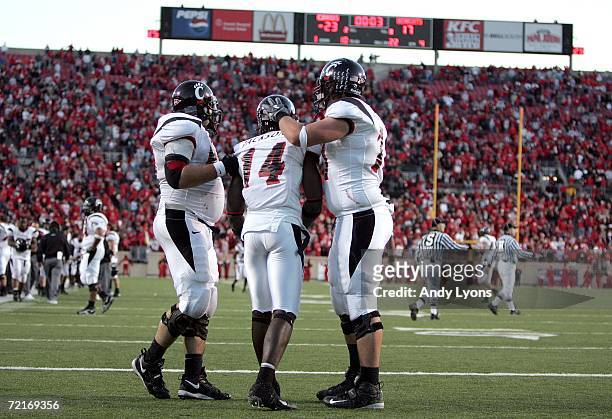 Earnest Jackson of the Cincinnati Bearcats is comforted by Jeff Reinstatler and Jeffrey Linkenbach in the endzone after Jackson was unable to catch a...