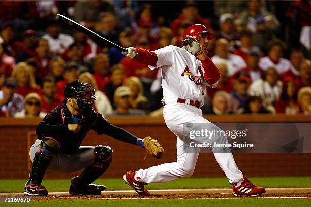 Scott Spiezio of the St. Louis Cardinals hits a two run triple against the New York Mets in game three of the NLCS against the New York Mets at Busch...