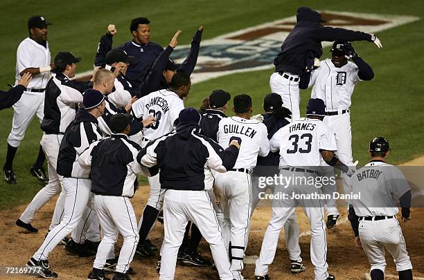 Players from the Detroit Tigers celebrate at home plate as Craig Monroe runs home on a 3-run walk-off home run, hit by Magglio Ordonez, against the...