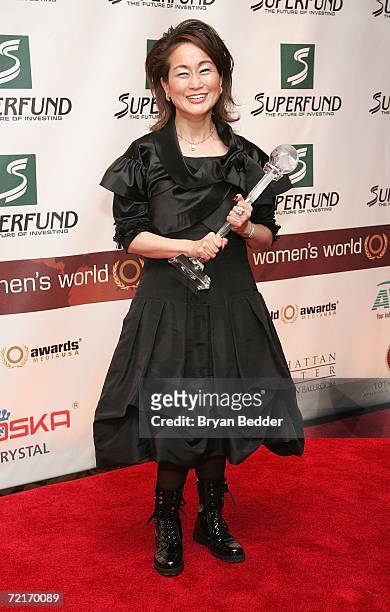 Miky Lee poses with her World Business Award in the media room backstage at the 3rd Annual Women's World Awards at Hammerstein Ballroom October 14,...