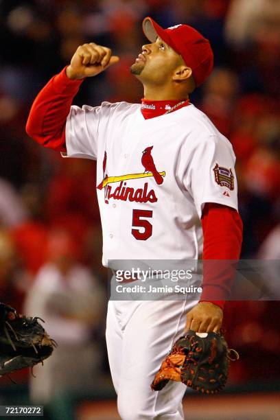 Albert Pujols of the St. Louis Cardinals celebrates after defeating the New York Mets 5-0 to take game three of the NLCS at Busch Stadium on October...