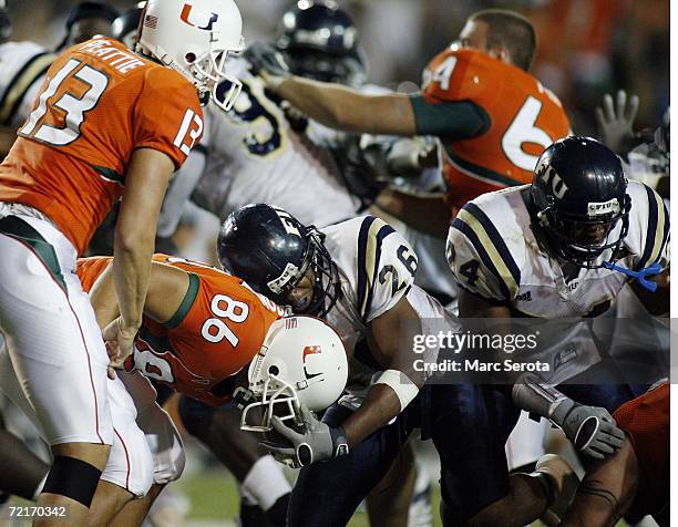 Jon Peattie and Ross Abramson of the University of Miami Hurricanes scuffle with Chris Smith and Marshall McDuffie Jr. #24 of the Florida...