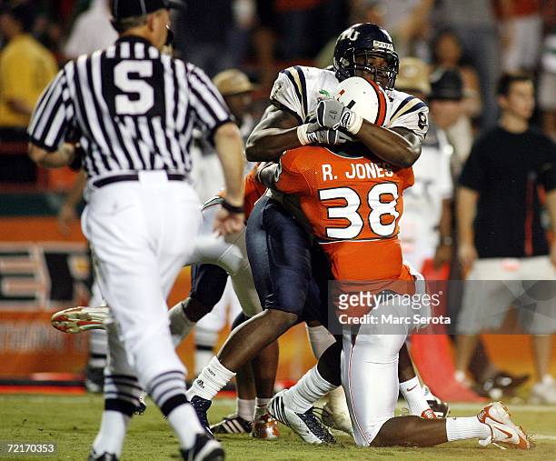 RaShaun Jones of the University of Miami Hurricanes scuffles with Samuel Smith of the Florida International University Panthers during a fight on the...