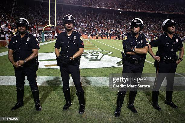 Police watch the field after a brawl broke out between players of the University of Miami Hurricanes and the Florida International University...