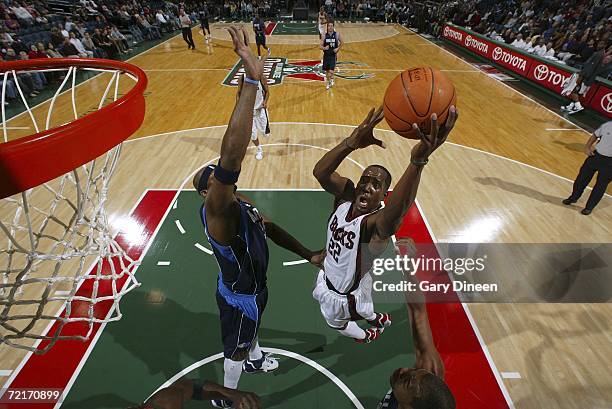 Milwaukee Bucks' Michael Redd shoots a layup against Dallas Mavericks' Erick Dampier at the Bradley Center October 14, 2006 in Milwaukee, Wisconsin....