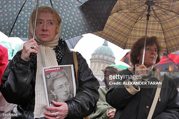 Woman holds a picture of a slain Russian journalist Anna Politkovskaya, during a rally marking the ninth day after her killing, in St.Petersburg, 15...