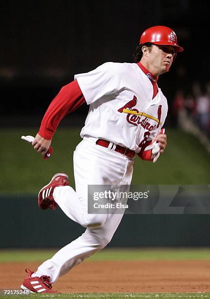 Scott Spiezio of the St. Louis Cardinals scores on a triple hit by Juan Encarnacion against the New York Mets during game four of the NLCS at Busch...