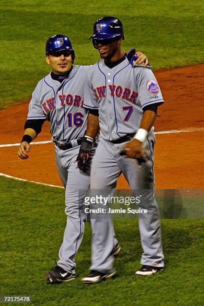 Jose Reyes and Paul Lo Duca of the New York Mets celebrate after scoring on a two RBI hit by Carlos Delgado in the sixth inning against the St. Louis...