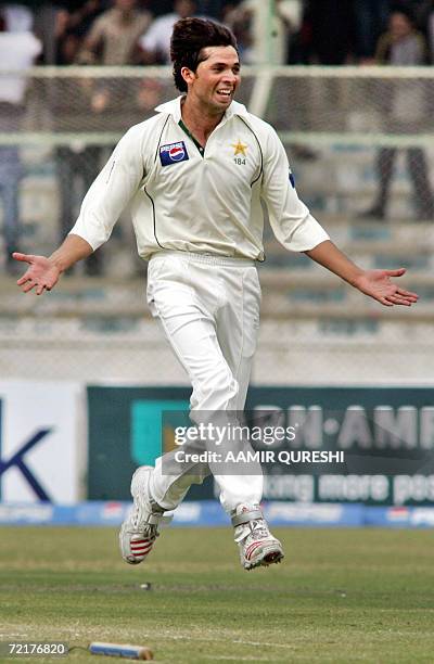 In this picture taken 01 February 2006, Pakistani cricketer Mohammad Asif leaps in the air as he celebrates after taking the wicket of Indian...