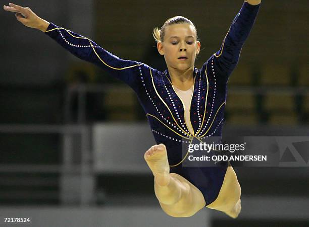 Erika Morel of France performs on the beam in the women's qualifiers at the Arena in Aarhus, 16 October 2006 at the 39th Artistic Gymnastics World...