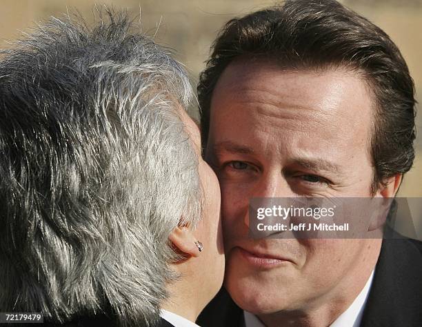 Annabel Goldie, leader of the Scottish Conservatives kisses party leader David Cameron as he arrives to address Scotland's leading disability...