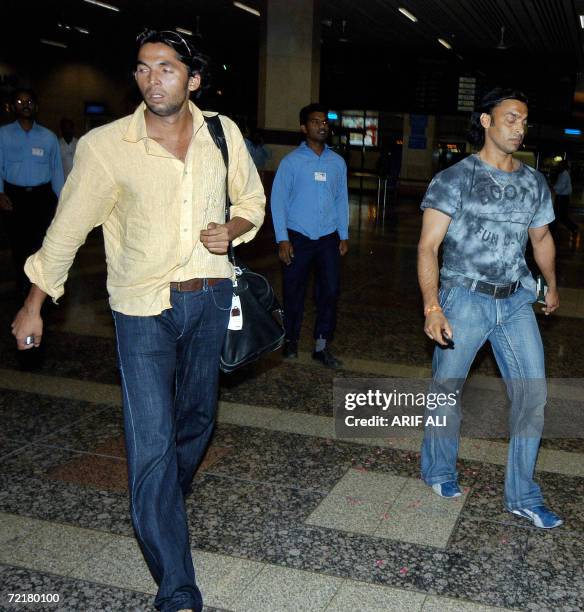 Pakistan fast bowlers Shoaib Akhtar and Mohammad Asif leave the Lahore Airport following their arrival from India, 16 October 2006. Pakistan recalled...