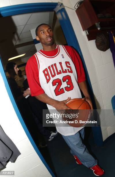 Kobe Bryant of the Los Angeles Lakers arrives wearing a Michael Jordan jersey before game four of the 2002 NBA Finals against the New Jersey Nets at...