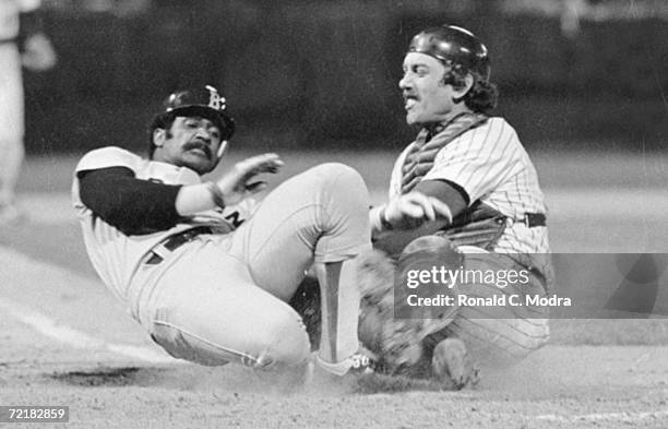 Jim Rice of the Boston Red Sox slides into catcher Roy Fosse of the Milwaukee Brewers in a game in 1979 in County Stadium in Milwaukee, Wisconsin