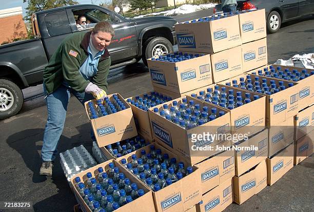 Michelle Otero and other New York State Electric & Gas employees pass out dry ice and water October 16, 2006 in Cheektawaga, New York a suburb of...