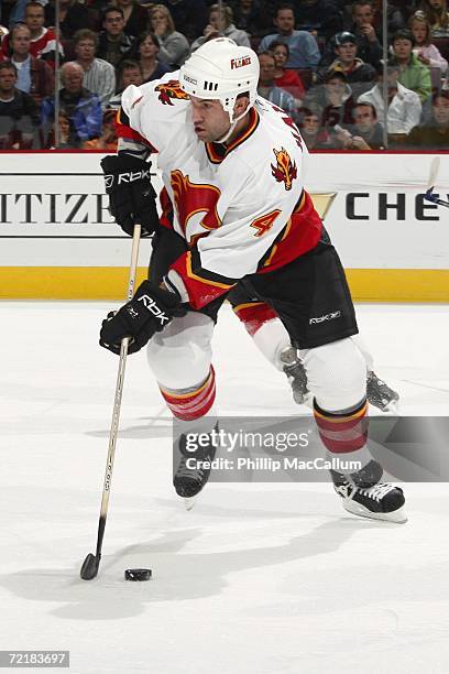 Roman Hamrlik of the Calgary Flames skates with the puck during a game against the Ottawa Senators at the Scotiabank Place on October 12, 2006 in...