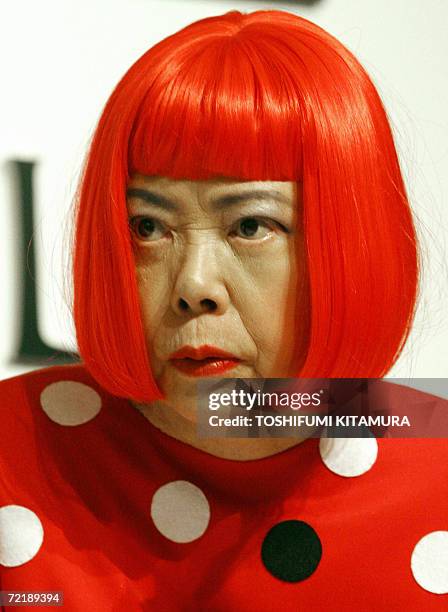 Japanese artist Yayoi Kusama greets journalists during the press conference in Tokyo, 17 October 2006. Kusama won the Paining section of the 18th...