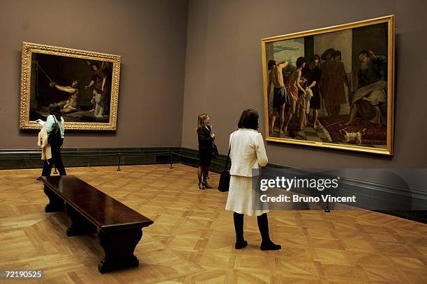 Members of the press look at works by Diego Rodriguez de Silva y Velazquez at the National Gallery on October 17, 2006 in London. The exhibition...