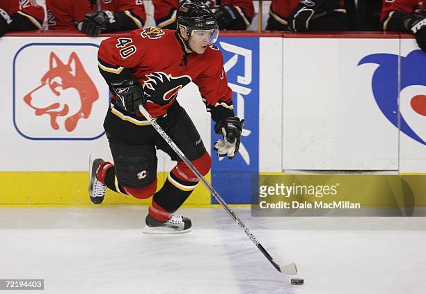 Left wing Alex Tanguay of the Calgary Flames skates with the puck against the San Jose Sharks during the NHL game at Pengrowth Saddledome on October...