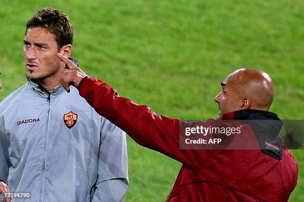 Roma's striker Francesco Totti speaks with his coach Luciano Spalletti during a trainning session on the eve of the Champions league group D football...