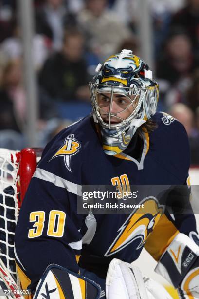 Ryan Miller of the Buffalo Sabres hugs the post as he follows the play along the boards during a preseason game against the Pittsburgh Penguins at...