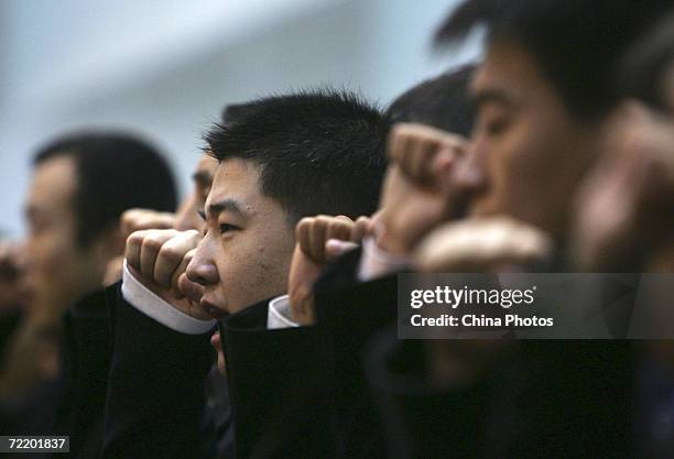 Plain clothes policemen participate in a ceremony to pledge to crack down on crime inside Beijing People's Police College October 17, 2006 in...