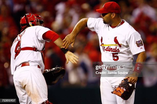 Albert Pujols and Yadier Molina of the St. Louis Cardinals celebrate after defeating the New York Mets 4-2 to take game five of the NLCS at Busch...