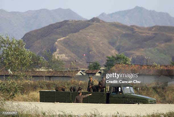 North Korean soldiers work on the outskirts of the North Korean city of Sinuiju in this picture taken on October 18, 2006 in the Chinese border city...