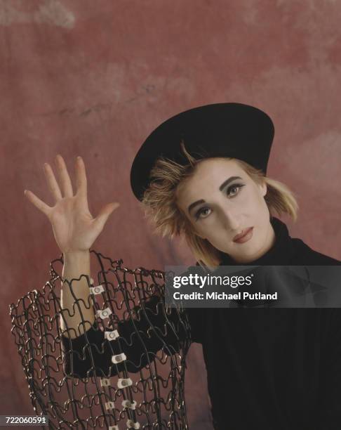 German singer and lead singer of pop group Propaganda, Claudia Brucken posed wearing a hat and holding a wire sculpture in a studio in London in 1985.