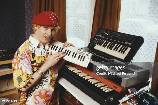 English singer-songwriter and guitarist Captain Sensible, formerly of punk group The Damned, pictured with various keyboards and synthesisers,...