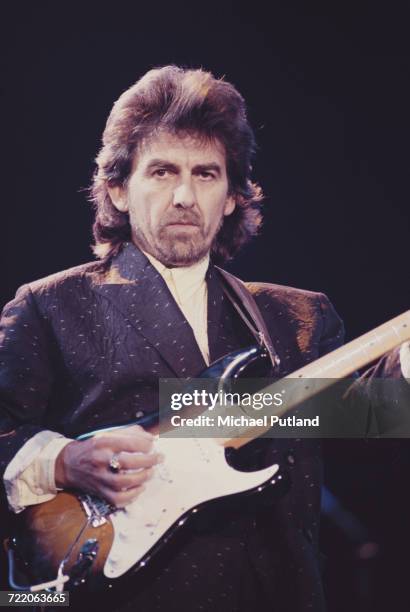 Former Beatle George Harrison performing with a Fender Stratocaster guitar at the Prince's Trust Concert, Wembley Arena, London, 6th June 1987.