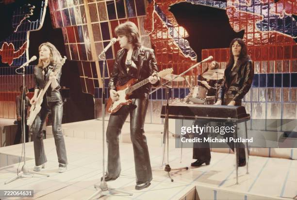 American rock singer Suzi Quatro performing with her group, all dressed in leather jackets and trousers, on the Christmas Day edition of the BBC TV...
