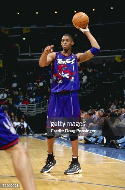 Tracy McGrady of the Toronto Raptors points as he's ready to pass the ball during the game against the Washington Wizards at the MCI Center in...