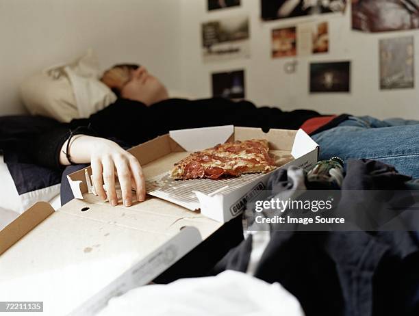 boy sleeping with pizza on bed - teenager bedroom stock pictures, royalty-free photos & images