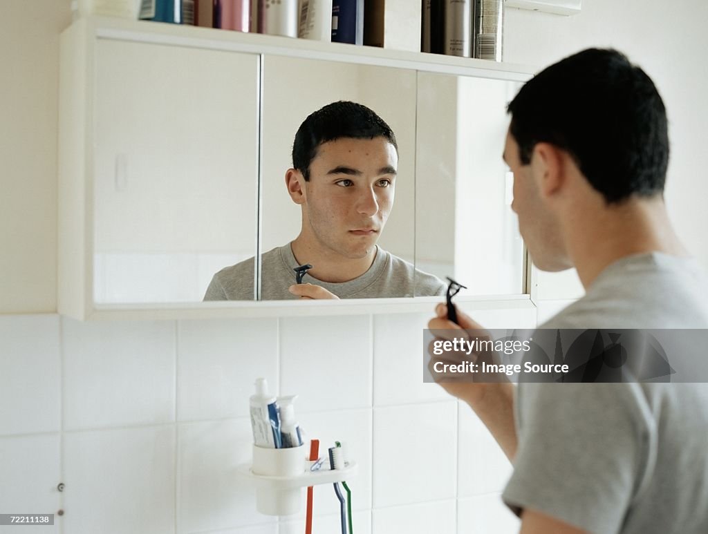 Teenage boy preparing to shave