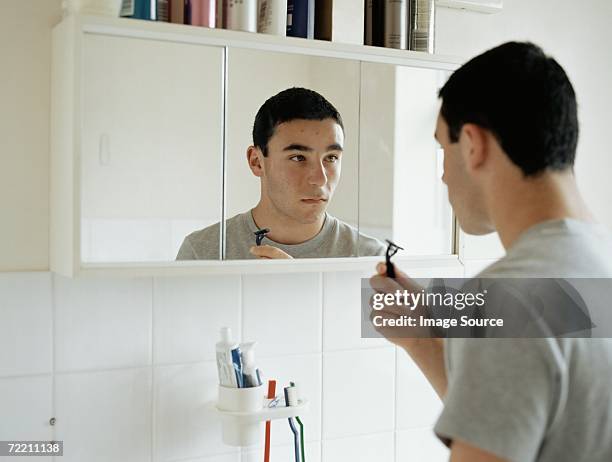 teenage boy preparing to shave - teenage boy shave imagens e fotografias de stock