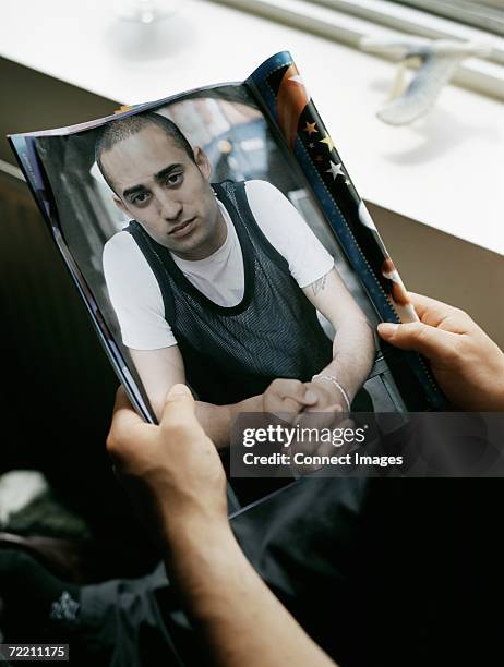 boy reading magazine in bedroom - holding magazine stock-fotos und bilder