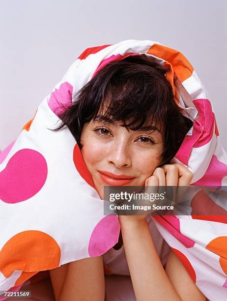 woman wrapped up duvet - tied to bed stockfoto's en -beelden