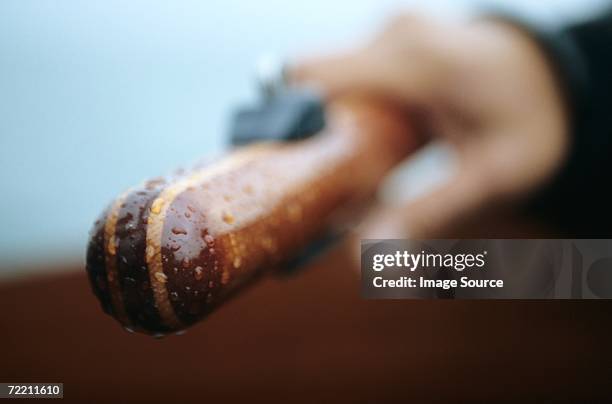 close-up of hand holding wooden handle - rudder stock pictures, royalty-free photos & images