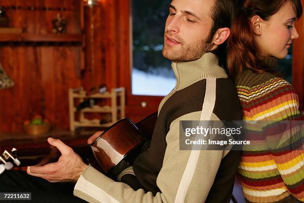 man playing guitar for girlfriend - serenading stock-fotos und bilder