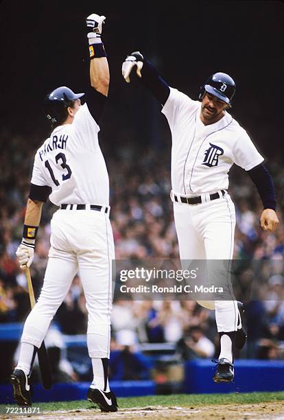 Kirk Gibson of the Detroit Tigers high fives with Lance Parrish of the Detroit Tigers after hitting his first home run in Game 5 of the 1984 World...