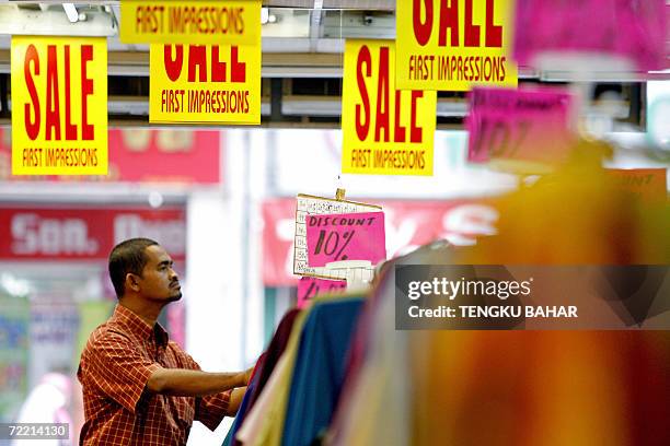Kuala Lumpur, MALAYSIA: To go with AFPLifestyle-religion-Islam-Ramadan-Malaysia,sched-FEATURE A shopper browses through a rack of discounted...
