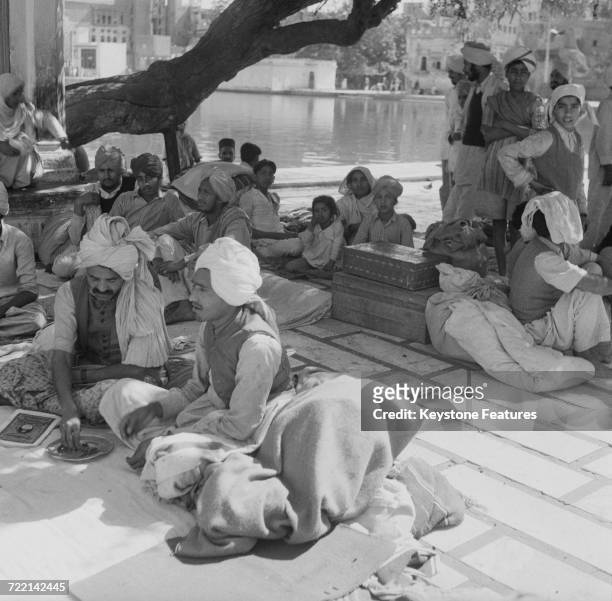 Refugees with their remaining belongings at the Golden Temple , the holiest shrine of Sikhism, in Amritsar, Punjab, after communal riots during the...
