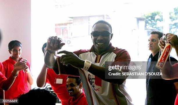 West Indies cricketer Dwayne Bravo dances at a promo ' Bucket Mein Cricket ' at the KFC outlet in Mumbai,19 October 2006. PETA protested the...