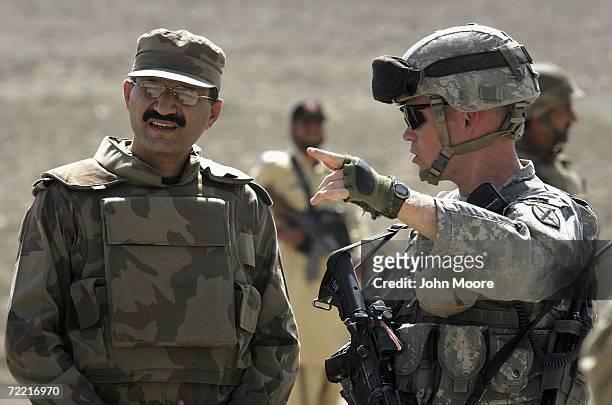 Army Captain Scott Horrigan talks with Pakistani Army Lieutenant Colonel Naseer about cross-border Taliban attacks as they conduct a joint operation...