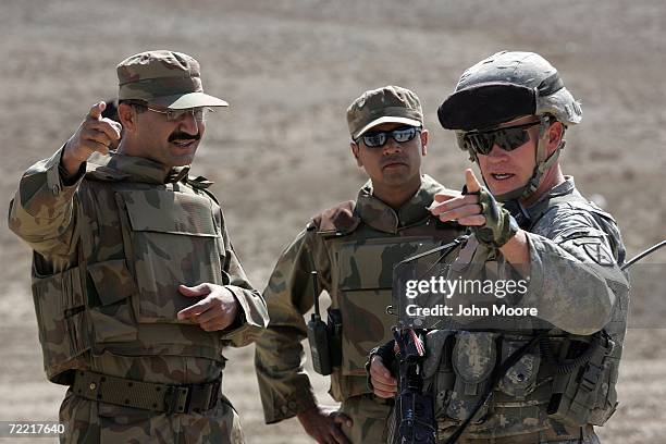 Pakistani Army Lt. Col. Naseer, , and U.S. Army Cpt. Scott Horrigan meet after coordinating a joint operation between Pakistani and Afghan troops...