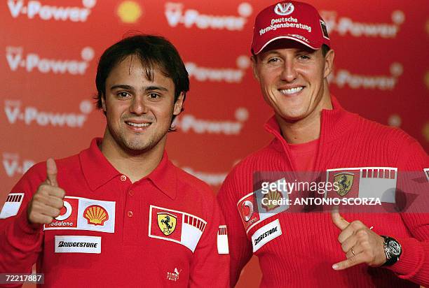 German Ferrari driver Michael Schumacher and teammate Brazilian Felipe Massa gesture at the end of a press conference, 19 October 2006, in Sao Paulo,...