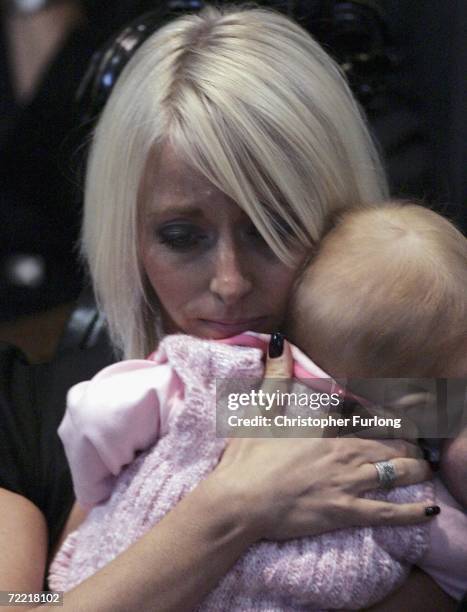 Lindsey Hunter, the wife of snooker star Paul Hunter cuddles their daughter Evie Rose during his funeral at Leeds Parish Church on October 19, 2006...