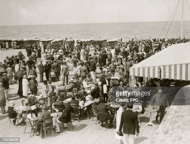 The crowded beach at Deauville during the holiday season, circa 1925.