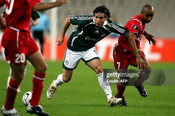 Degu Baruch of Hapoel Tel Aviv fights for the ball with Panathinaikos' Sebastian Romero during their first round UEFA Cup group stage football game...